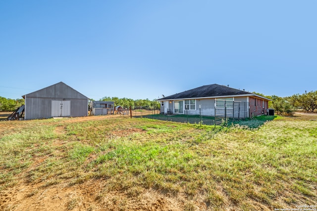 view of yard featuring central AC and an outbuilding