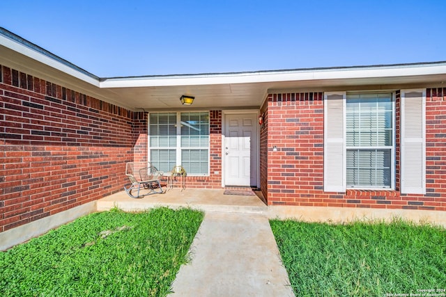 property entrance with brick siding