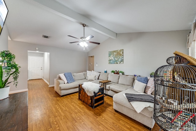 living room featuring visible vents, baseboards, ceiling fan, light wood-style floors, and vaulted ceiling with beams