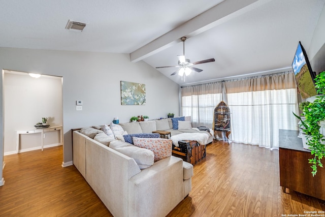 living room with baseboards, lofted ceiling with beams, visible vents, ceiling fan, and wood finished floors