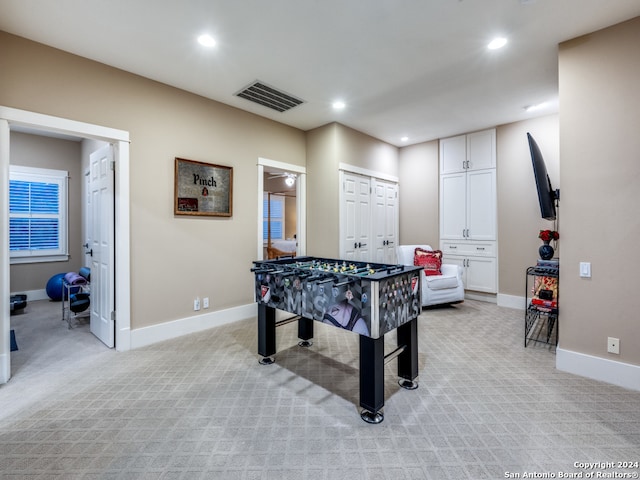 playroom featuring light carpet and ceiling fan