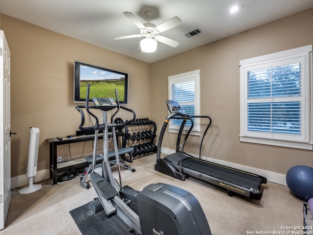 exercise room featuring light carpet and ceiling fan