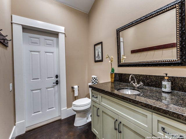 bathroom with wood-type flooring, vanity, and toilet