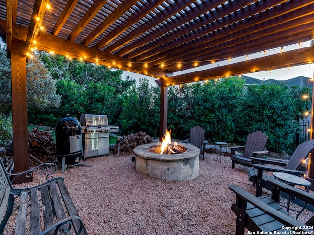 view of patio with a fire pit and a grill