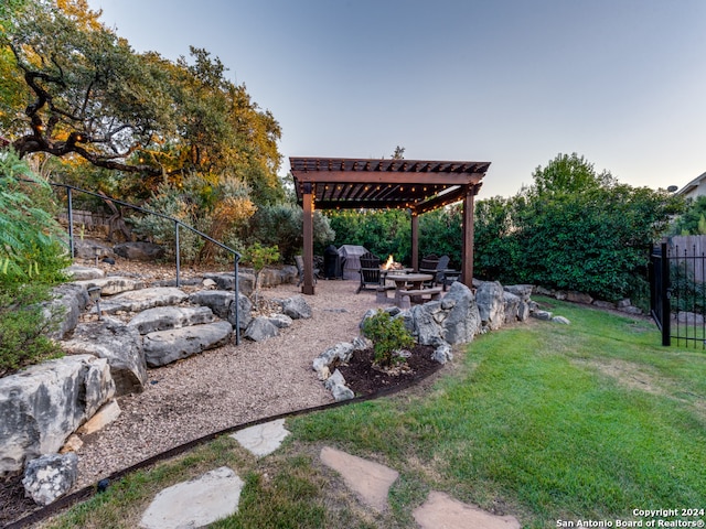 view of yard featuring an outdoor fire pit, a patio, and a pergola