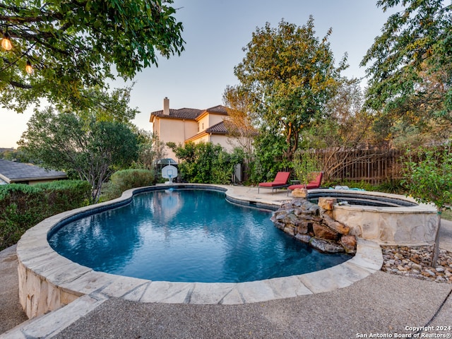 view of pool featuring an in ground hot tub and a patio area