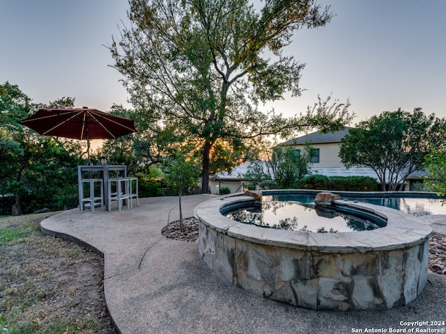 exterior space with a hot tub and a patio area