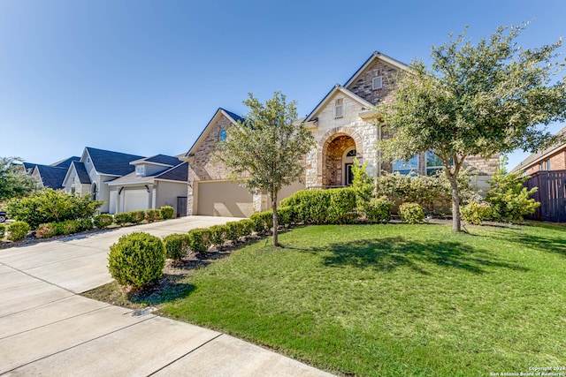 view of front of home with a front yard and a garage