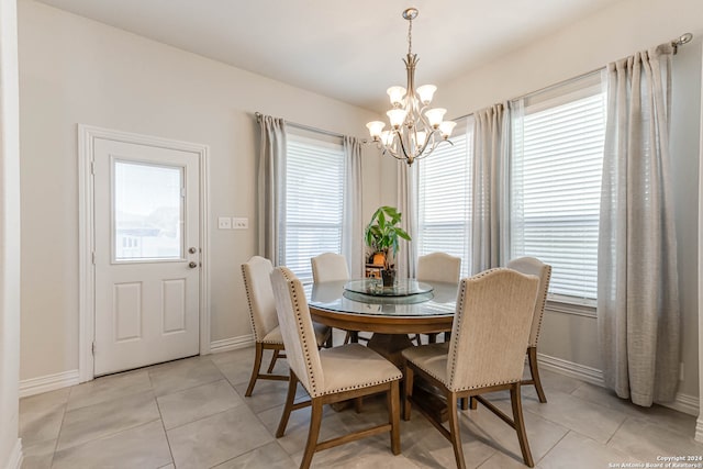 dining space featuring a notable chandelier and light tile patterned floors