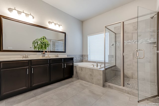 bathroom featuring tile patterned flooring, vanity, and separate shower and tub