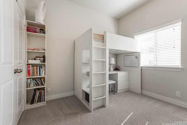 unfurnished bedroom featuring light carpet