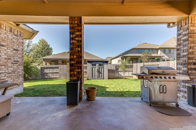 view of patio / terrace with a grill and a storage unit