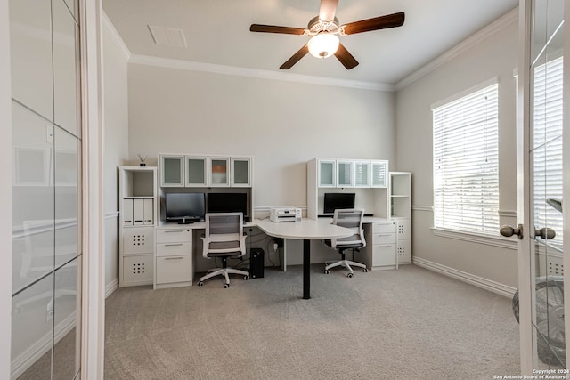 home office with light carpet, ornamental molding, ceiling fan, and a healthy amount of sunlight