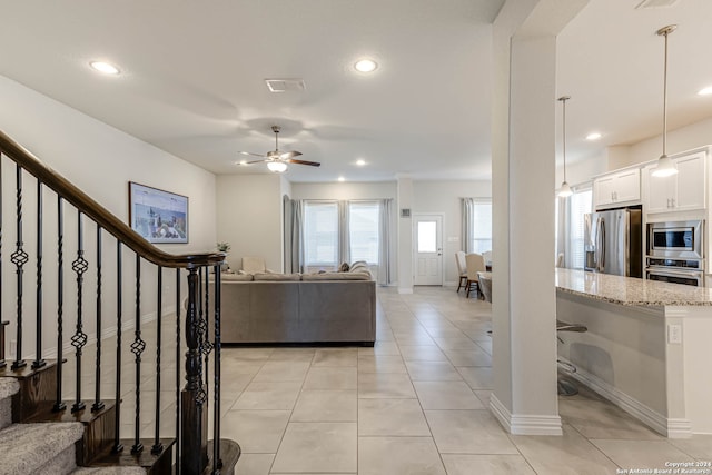 living room featuring ceiling fan and light tile patterned flooring