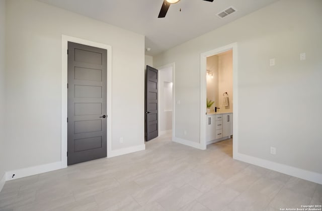 unfurnished bedroom featuring ceiling fan and ensuite bath