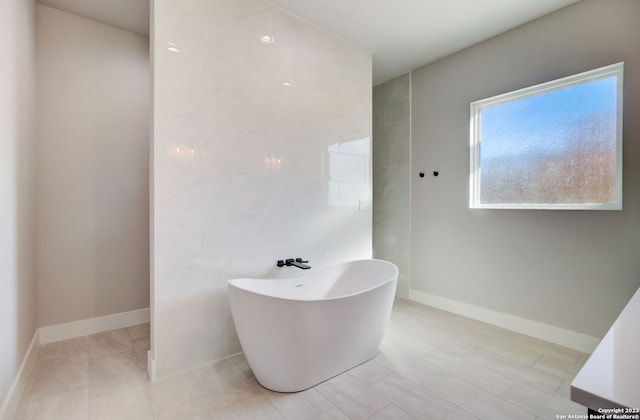 bathroom with tile walls and a bathing tub