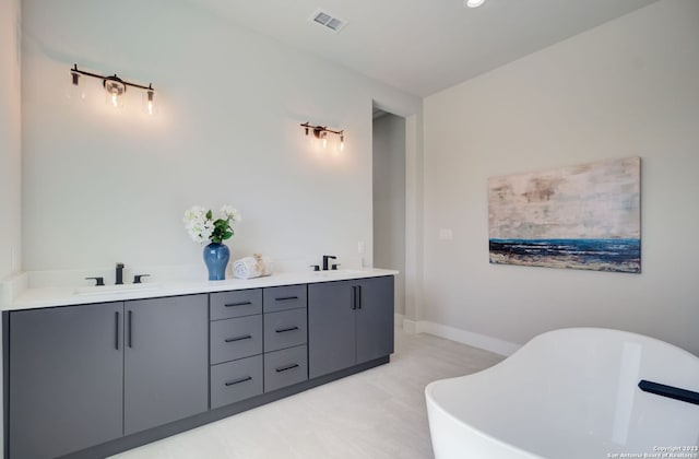 bathroom with a bath and vanity