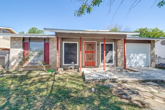 single story home with a garage and a front yard