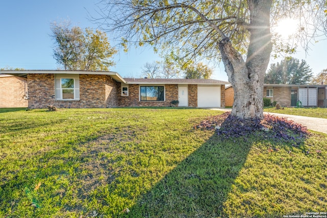 ranch-style house with a front yard and a garage