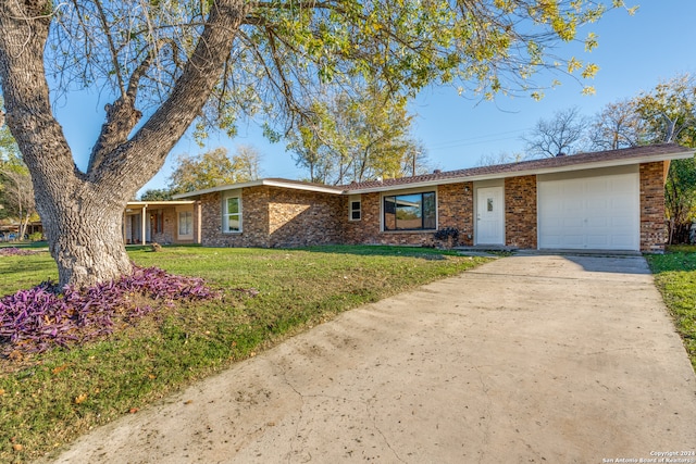 single story home with a garage and a front lawn