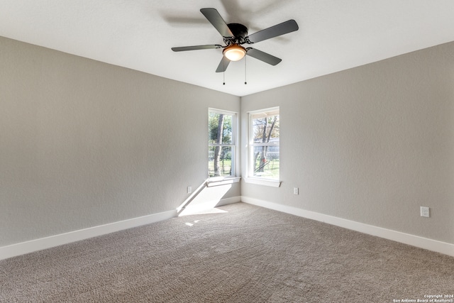 spare room with carpet floors and ceiling fan