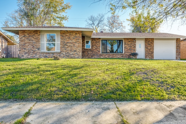 ranch-style house with a garage and a front lawn