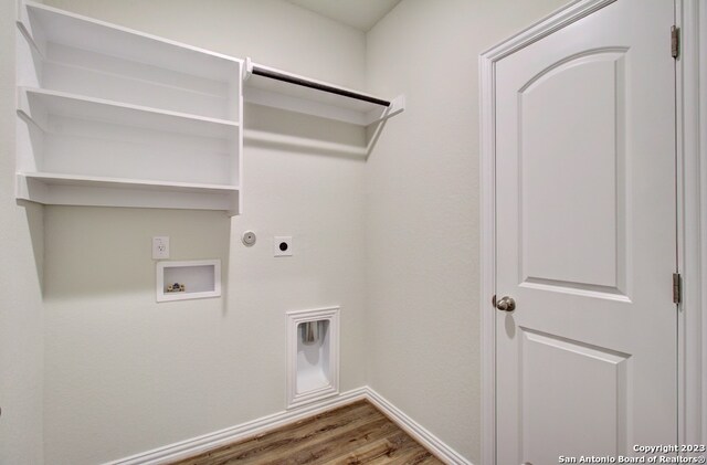 clothes washing area featuring wood-type flooring, washer hookup, and hookup for an electric dryer