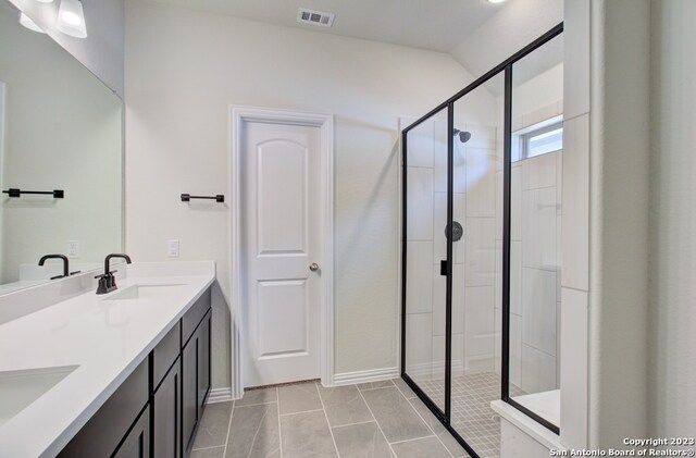 bathroom with vanity, tile patterned floors, and walk in shower