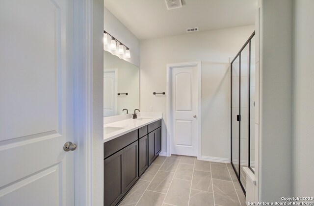 bathroom featuring vanity and an enclosed shower