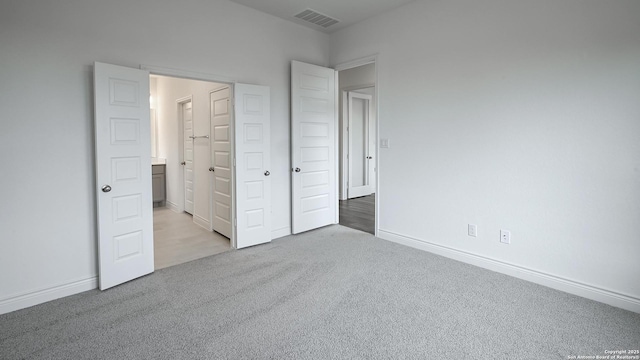 unfurnished bedroom featuring light carpet