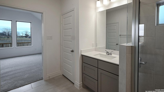 bathroom with vanity, a shower with shower door, and tile patterned floors