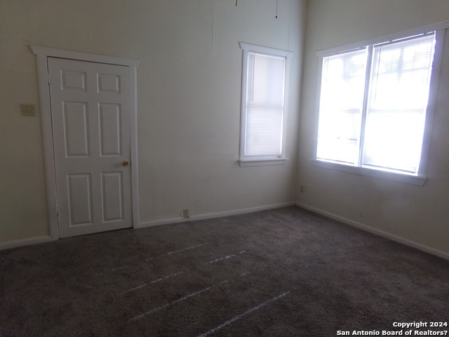 empty room with dark carpet