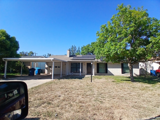 view of front of home featuring a front yard and solar panels