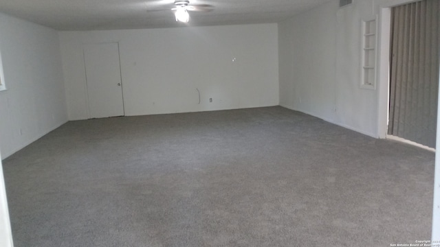 carpeted spare room with ceiling fan