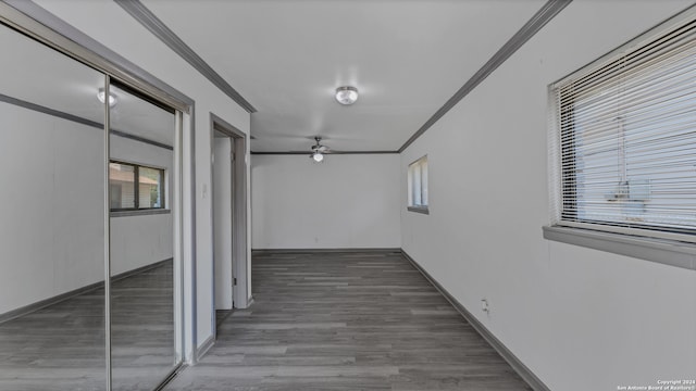 hall featuring wood-type flooring and crown molding