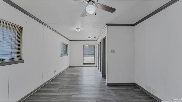 corridor with dark hardwood / wood-style floors and crown molding