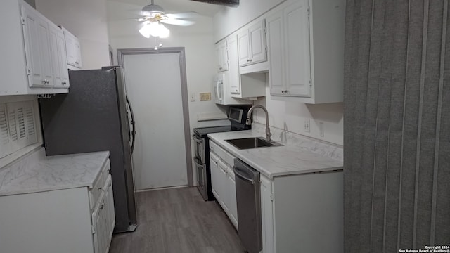 kitchen featuring ceiling fan, stainless steel appliances, sink, light hardwood / wood-style floors, and white cabinetry