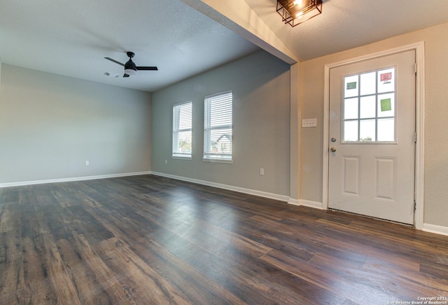 foyer with a ceiling fan, dark wood-type flooring, and baseboards