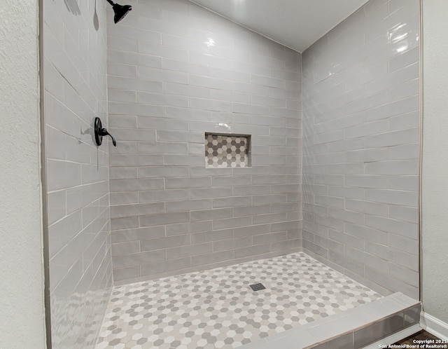 bathroom with tiled shower