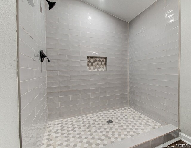 bathroom with a tile shower