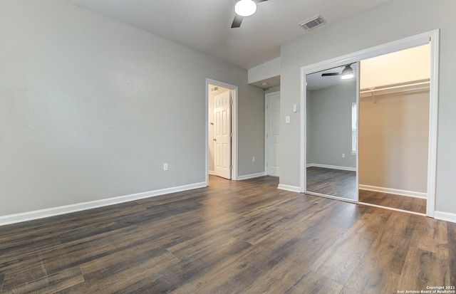 unfurnished bedroom with baseboards, dark wood finished floors, visible vents, a closet, and ceiling fan
