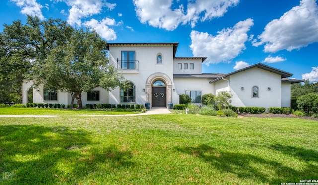 mediterranean / spanish house with a front lawn