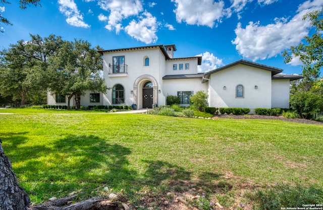 mediterranean / spanish home featuring a front lawn