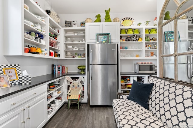 kitchen featuring white cabinets, stainless steel appliances, and dark hardwood / wood-style floors