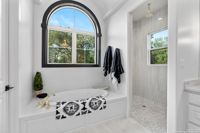 bathroom featuring independent shower and bath, vanity, and tile patterned floors