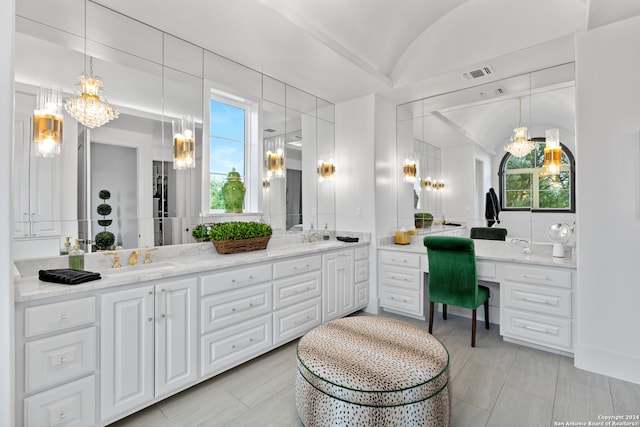 bathroom with lofted ceiling and vanity