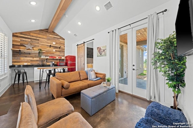 living room featuring wooden walls, vaulted ceiling with beams, a barn door, and french doors