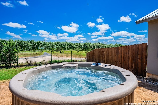 view of swimming pool with a hot tub