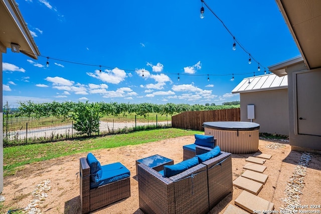 view of patio / terrace with a hot tub