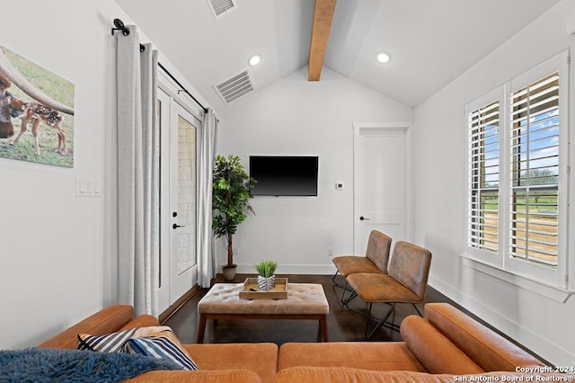 living room featuring hardwood / wood-style flooring, a wealth of natural light, a barn door, and vaulted ceiling with beams